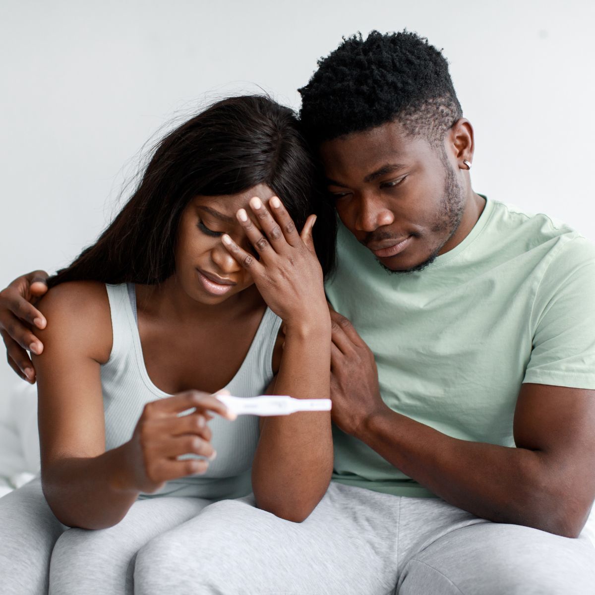 Young couple grieving a failed pregnancy